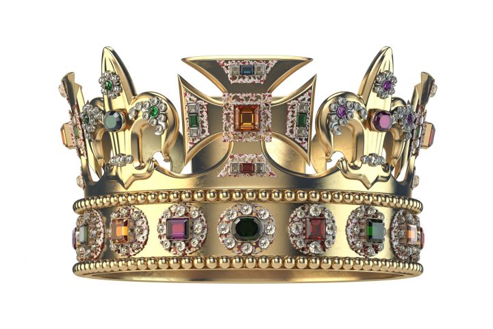 Gold crown with jewels isolated on white.