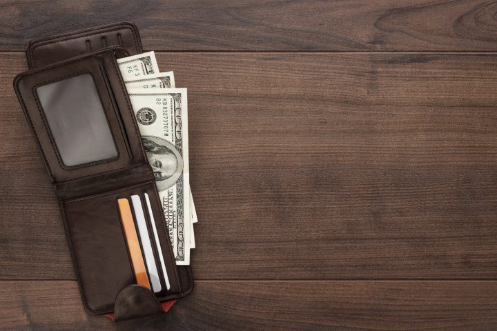 Purse With Money On The Wooden Table