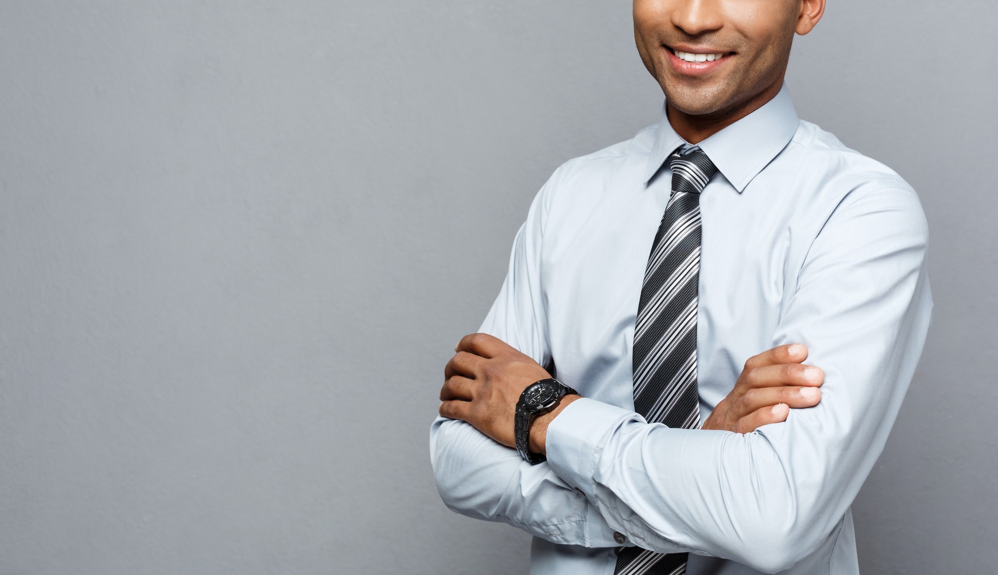 Business Concept - Happy professional african american businessman confident arms crossed